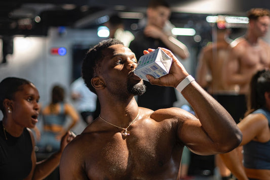 man drinking water at gym