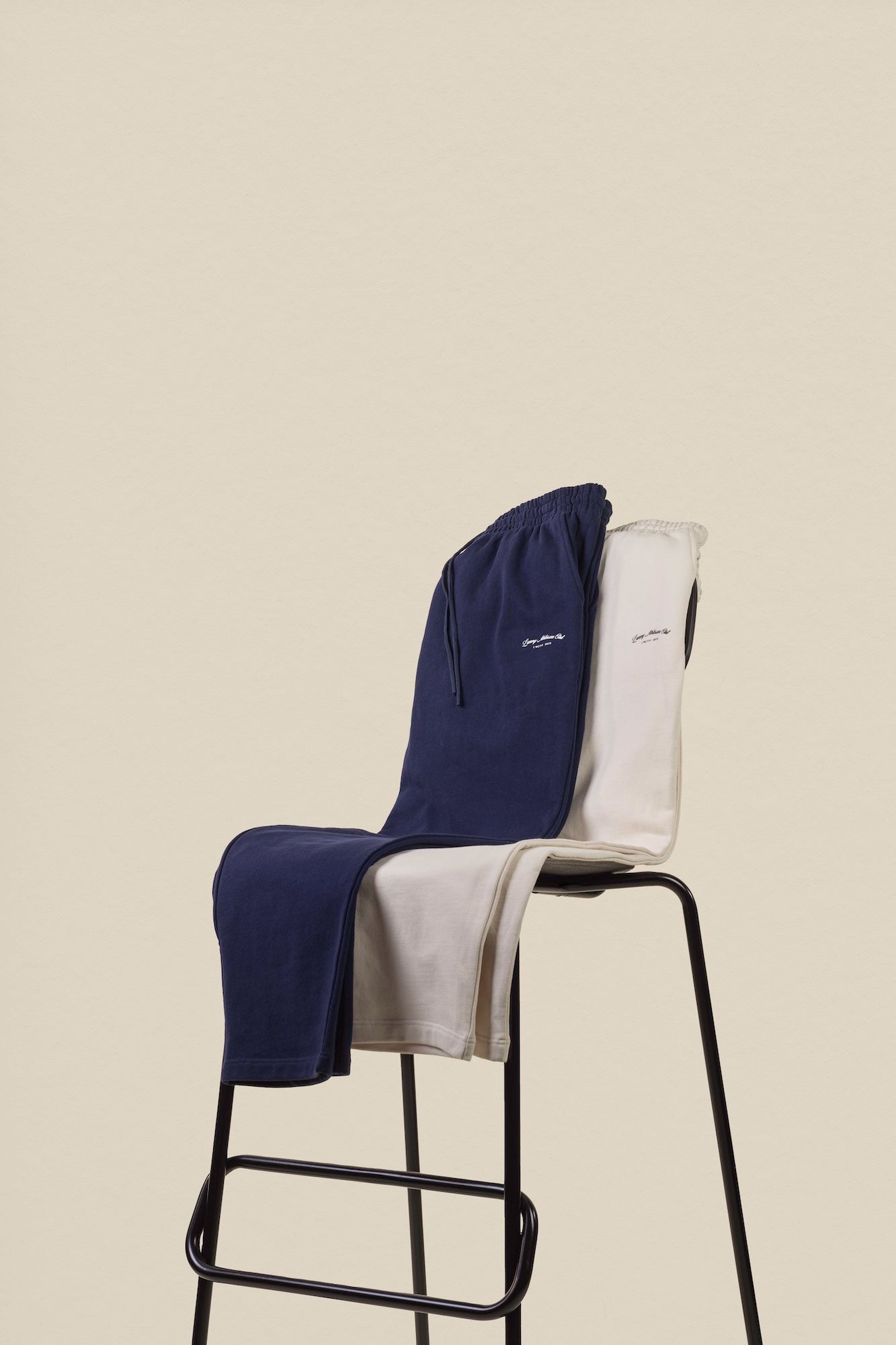 navy and ivory pants on chair